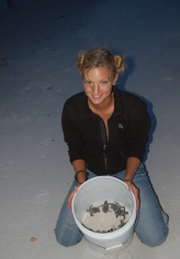 Michelle Jewell with sea turtle hatchlings